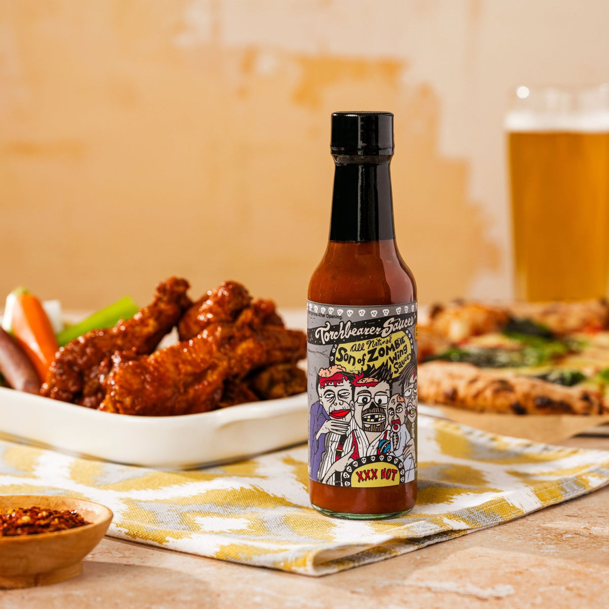 Son of Zombie Sweet & Smoky Hot Sauce on food table - TorchBearer Sauces