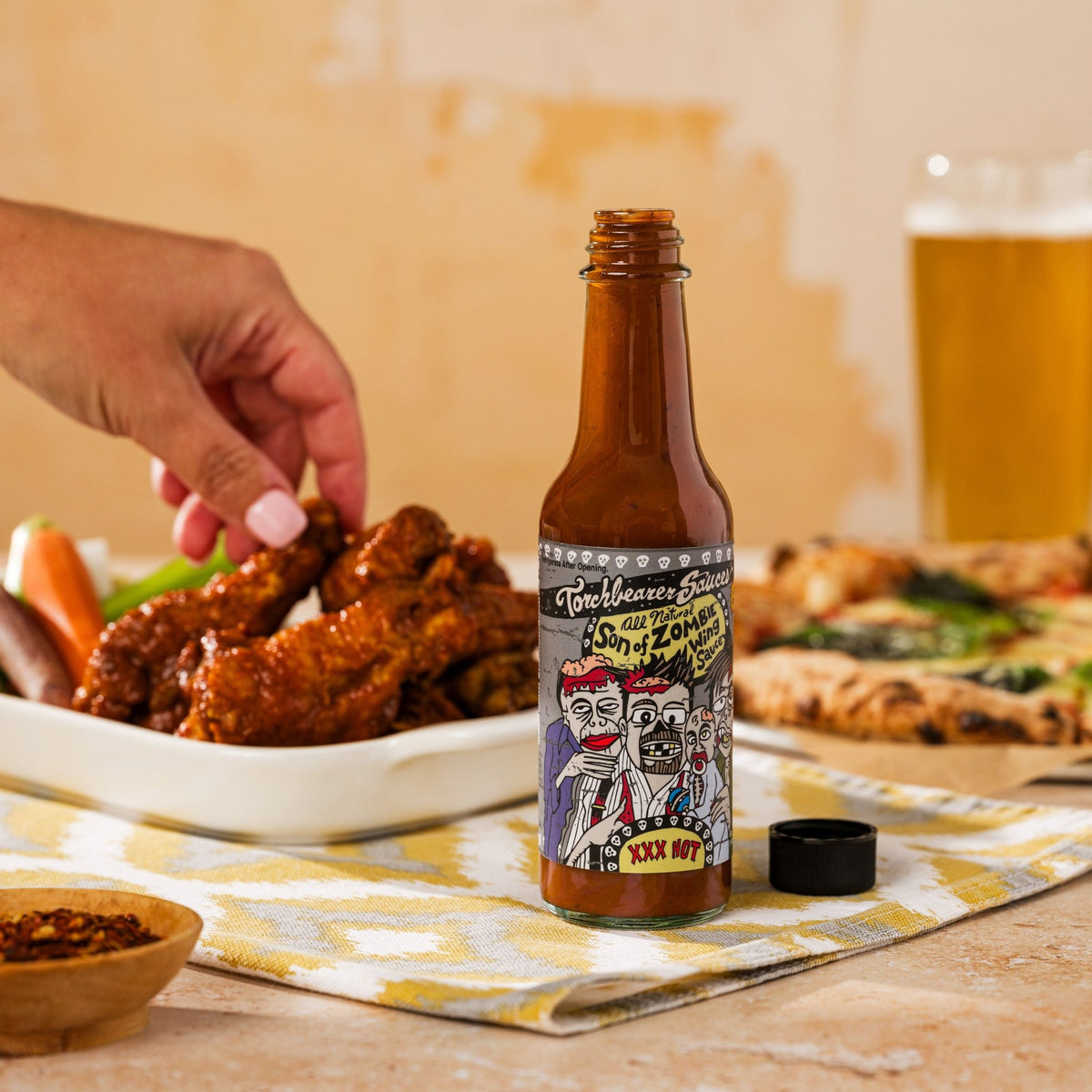 Son of Zombie Sweet & Smoky Hot Sauce people holding - TorchBearer Sauces