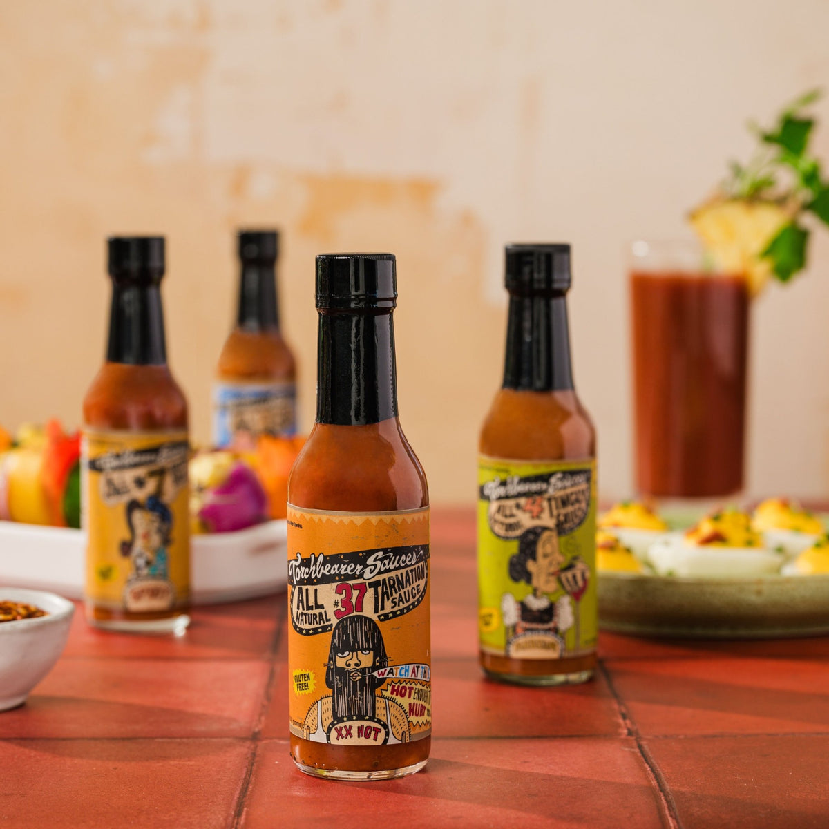 Tarnation Sauce™ in the front with other TorchBearer Sauces in the background
